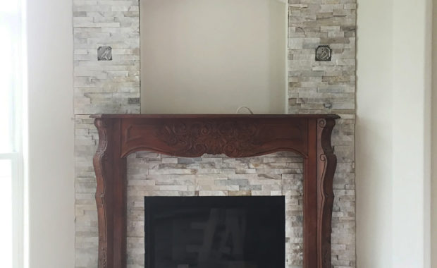 fireplace with stone and wood surround