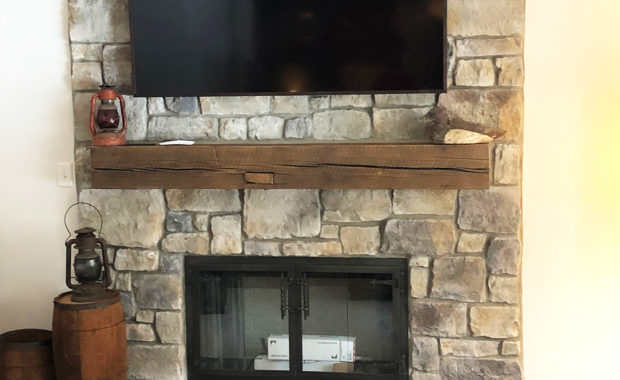 wood burning fireplace with stone